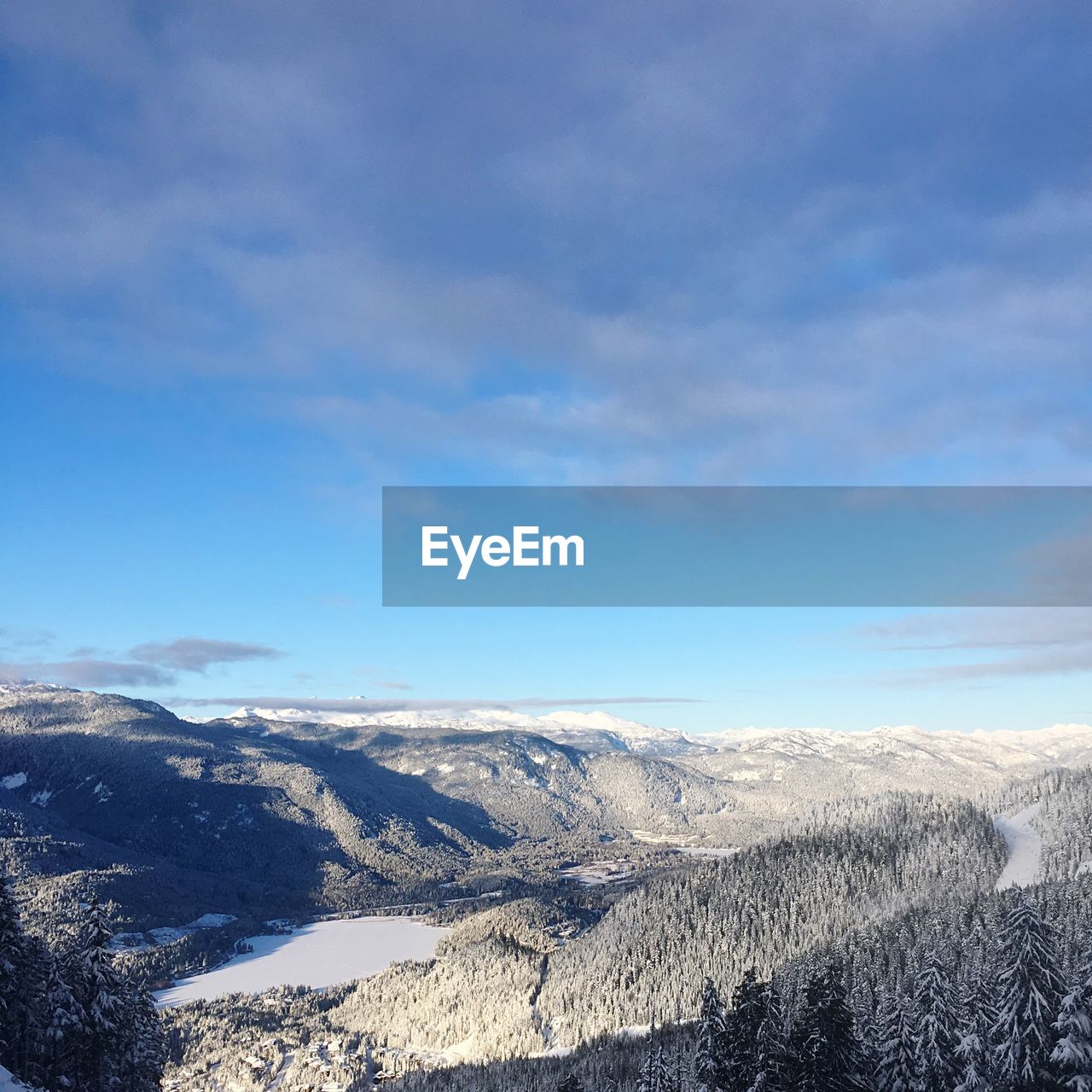 Scenic view of snowcapped mountains against blue sky