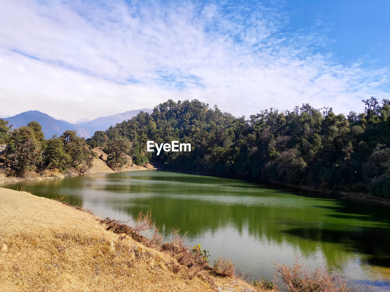 Scenic view of lake and mountains against sky in india