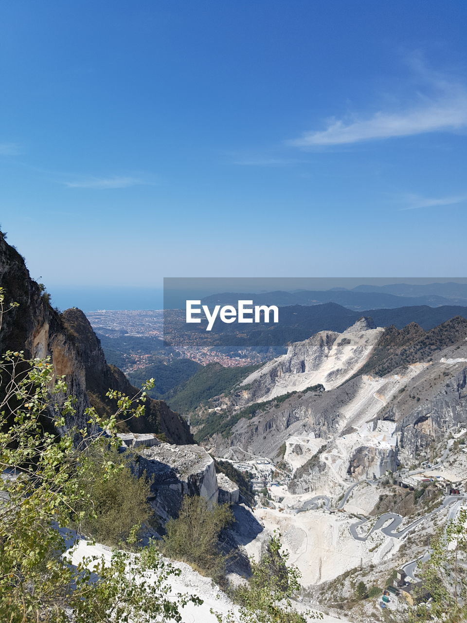 Scenic view of mountains against blue sky