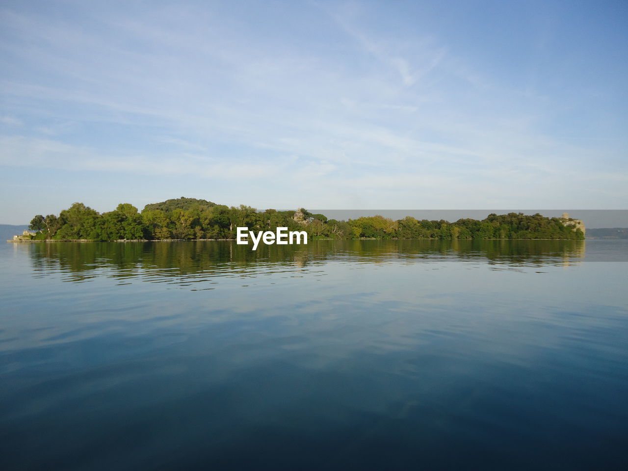 Scenic view of lake bolsena against sky