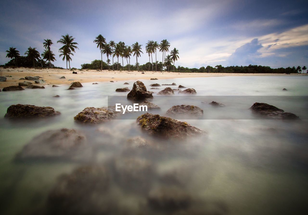 SURFACE LEVEL OF ROCKS IN SEA AGAINST SKY