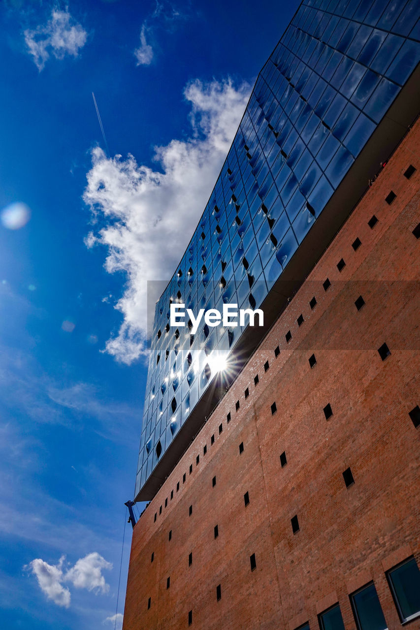 Low angle view of modern building against blue sky