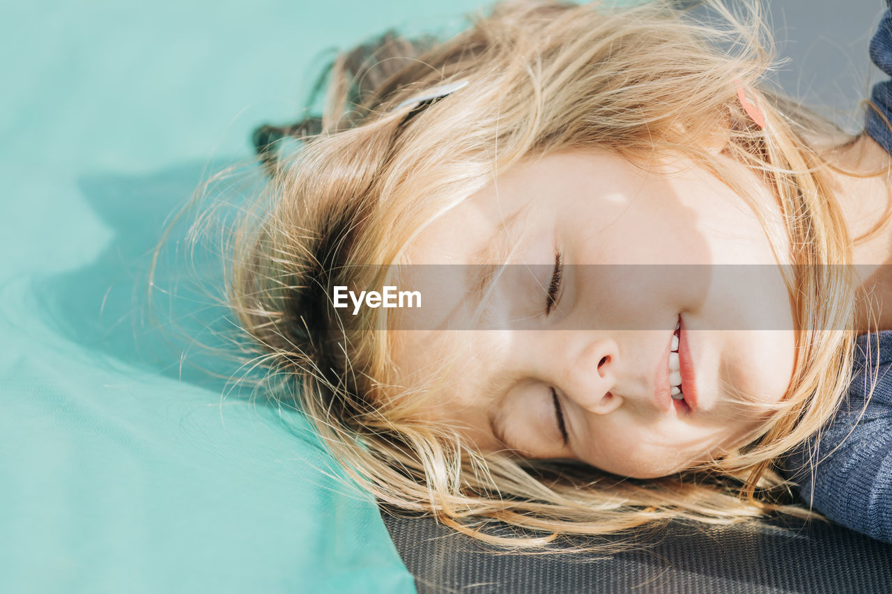 High angle view of cute girl sleeping on floor