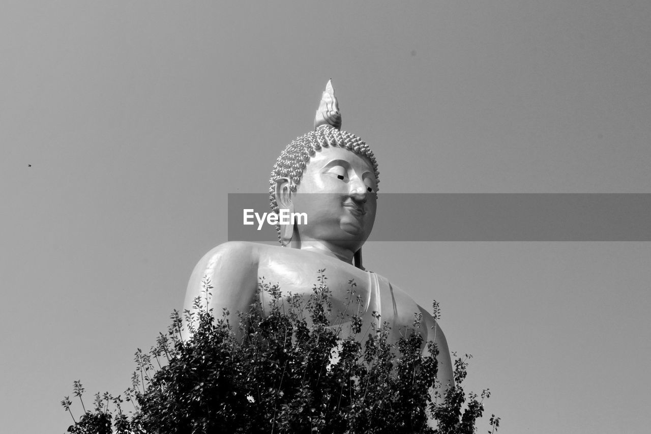 Low angle view of statue against sky