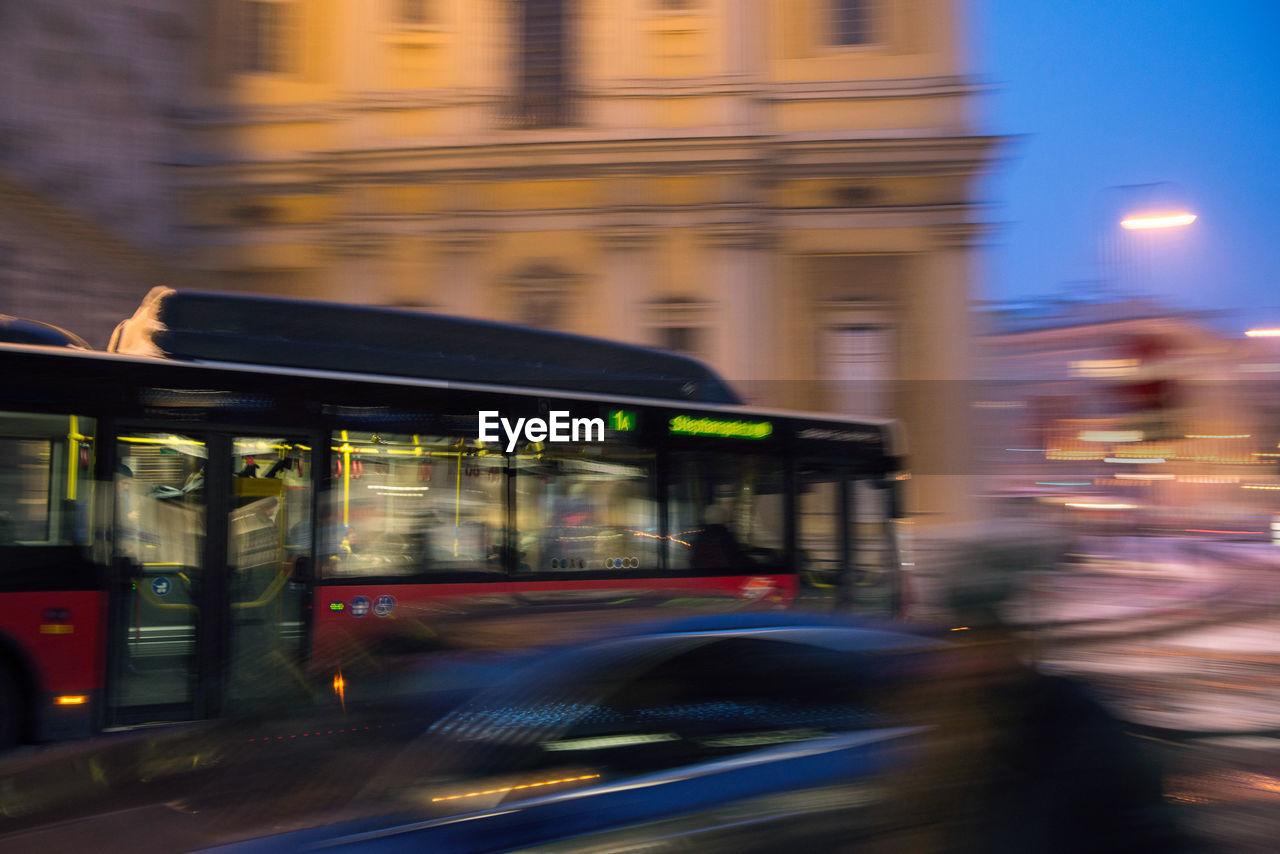 BLURRED MOTION OF ILLUMINATED STREET AT NIGHT