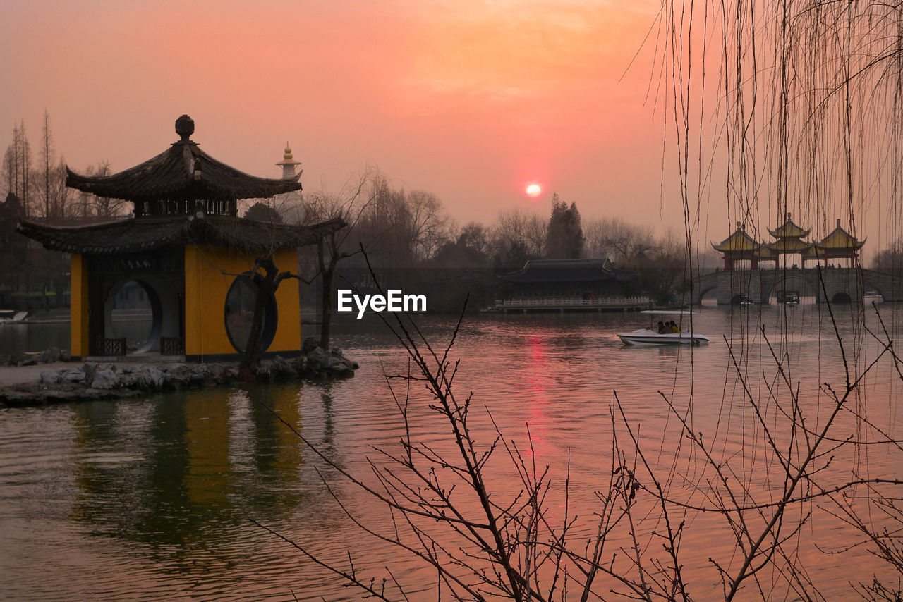 Scenic view of lake against sky during sunset