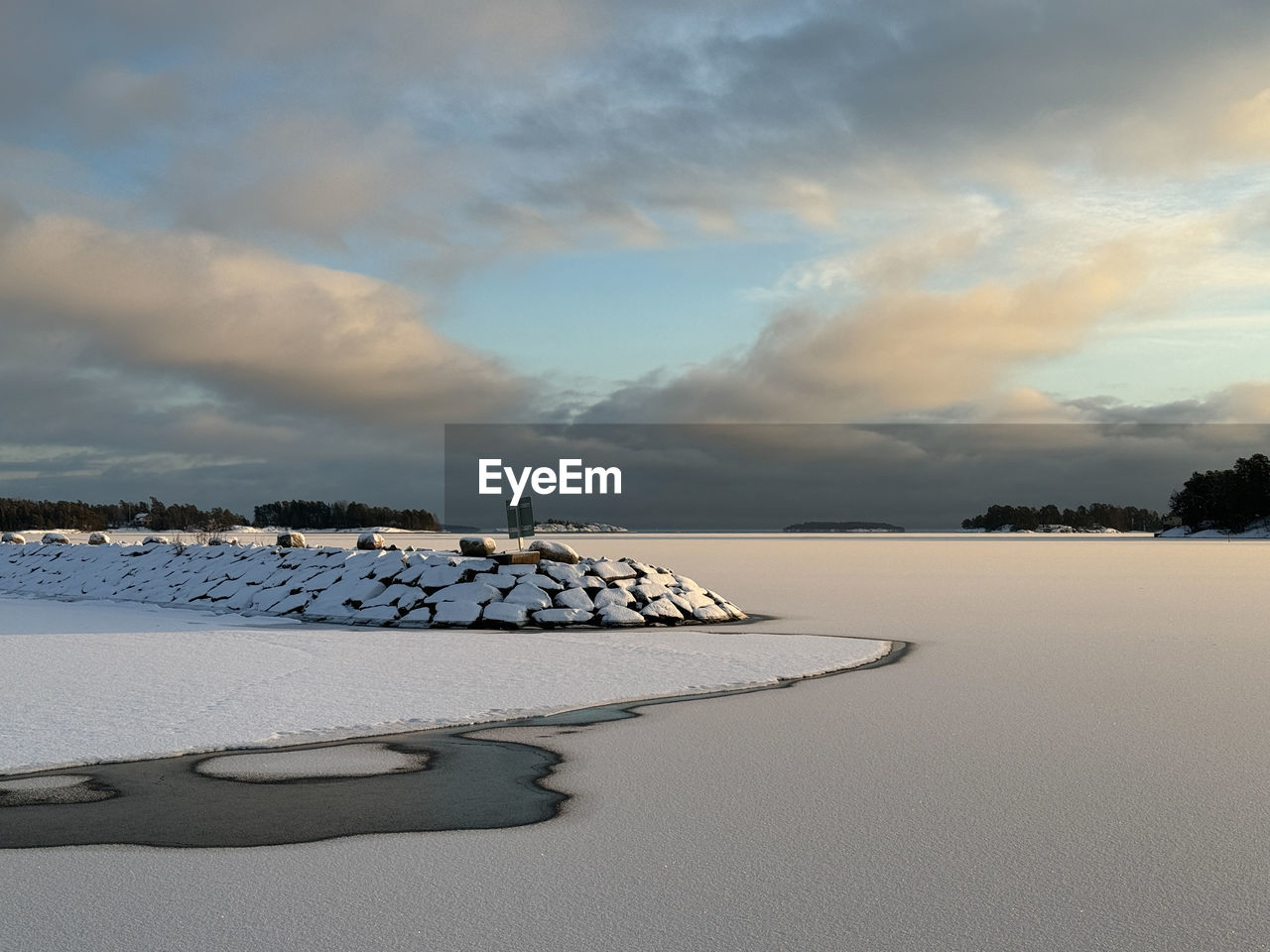 sky, cloud, water, land, scenics - nature, beauty in nature, sea, environment, nature, snow, landscape, beach, winter, tranquility, horizon, shore, morning, tranquil scene, sand, dramatic sky, reflection, no people, ocean, travel destinations, wave, travel, outdoors, cold temperature, non-urban scene, dusk, coast, coastline, sunlight, idyllic, seascape, tourism, tree, horizon over water, day