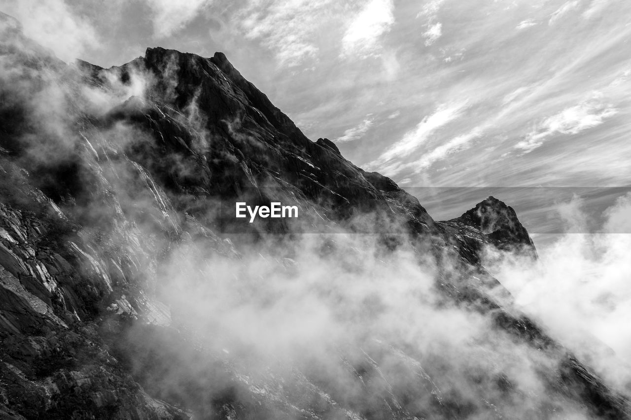 Scenic view of mountain kinabalu against sky. black and white 