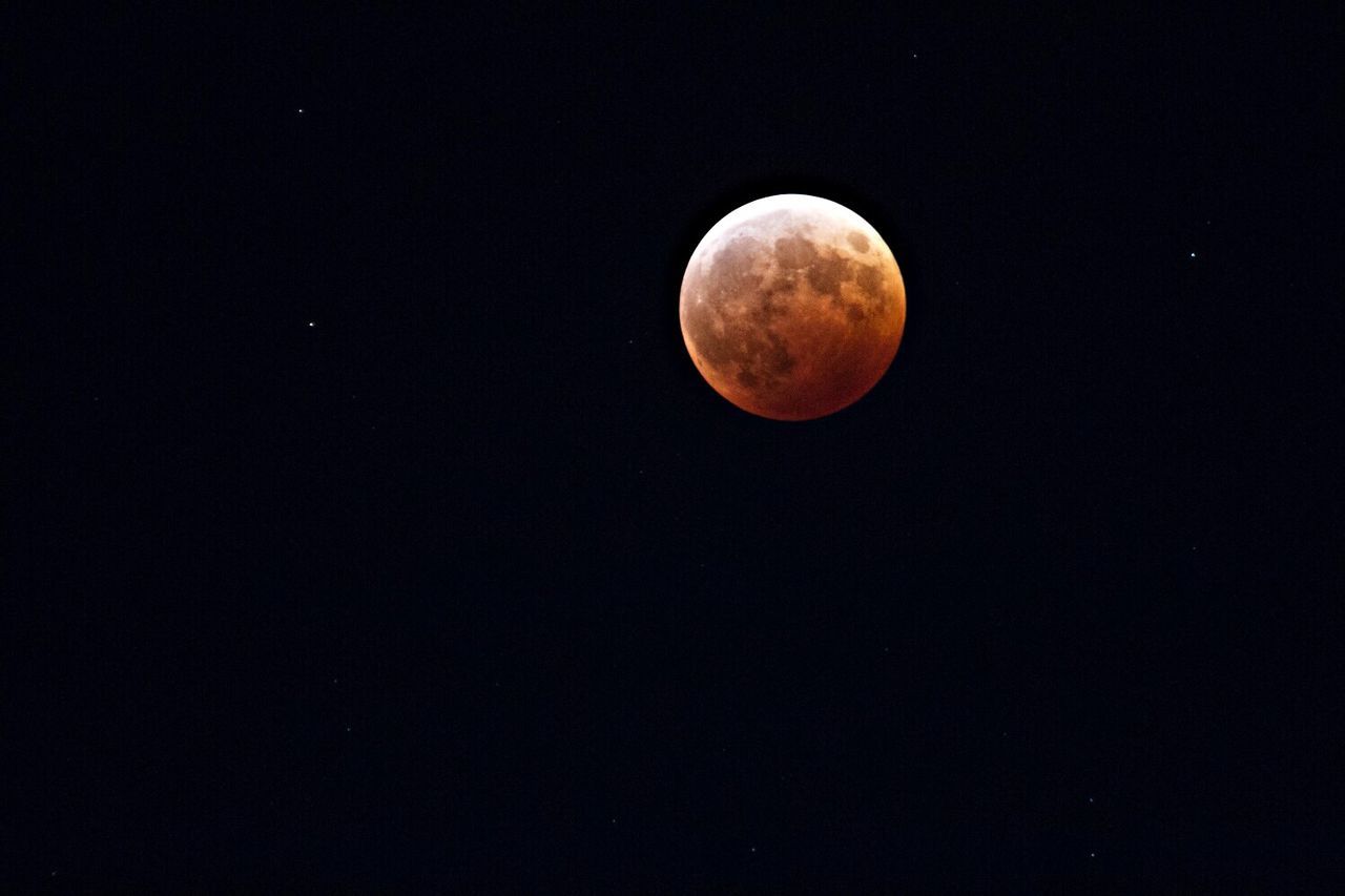 Low angle view of full moon in night sky