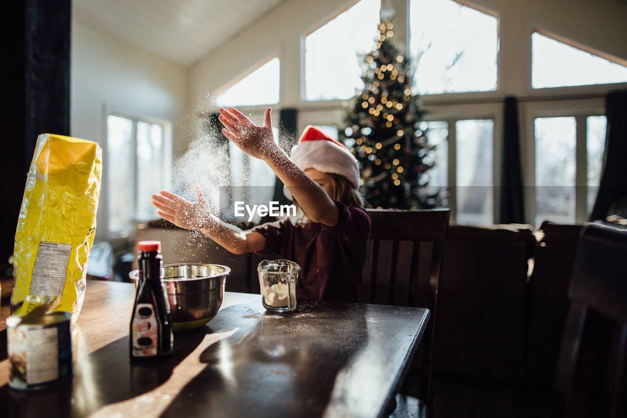 Boy doing christmas baking and playing with flour