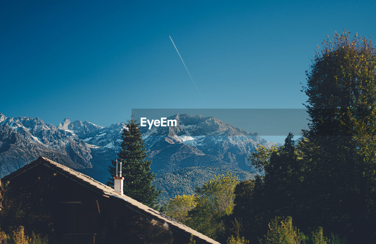 Scenic view of mountains against clear blue sky