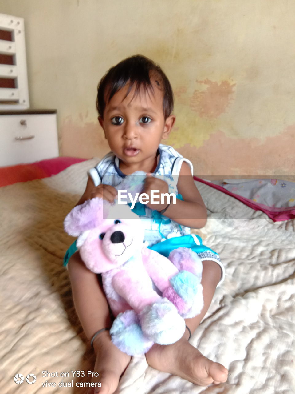 PORTRAIT OF CUTE GIRL WITH TOY AT HOME