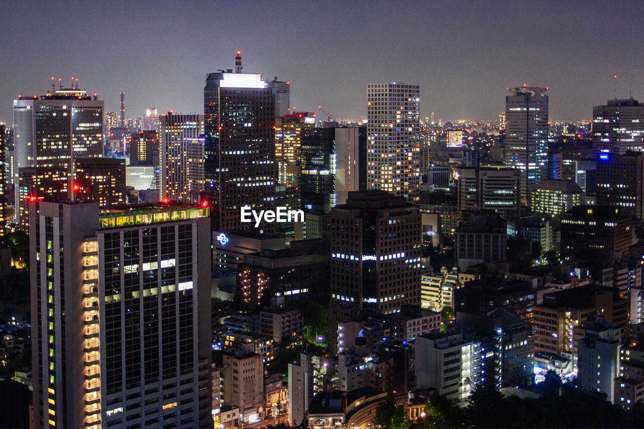 ILLUMINATED BUILDINGS AGAINST SKY AT NIGHT