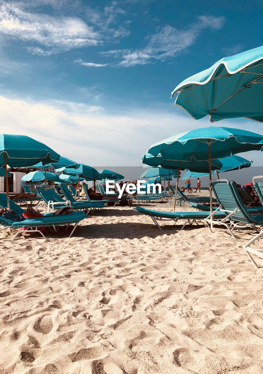 Umbrellas and lounge chairs on shore of beach