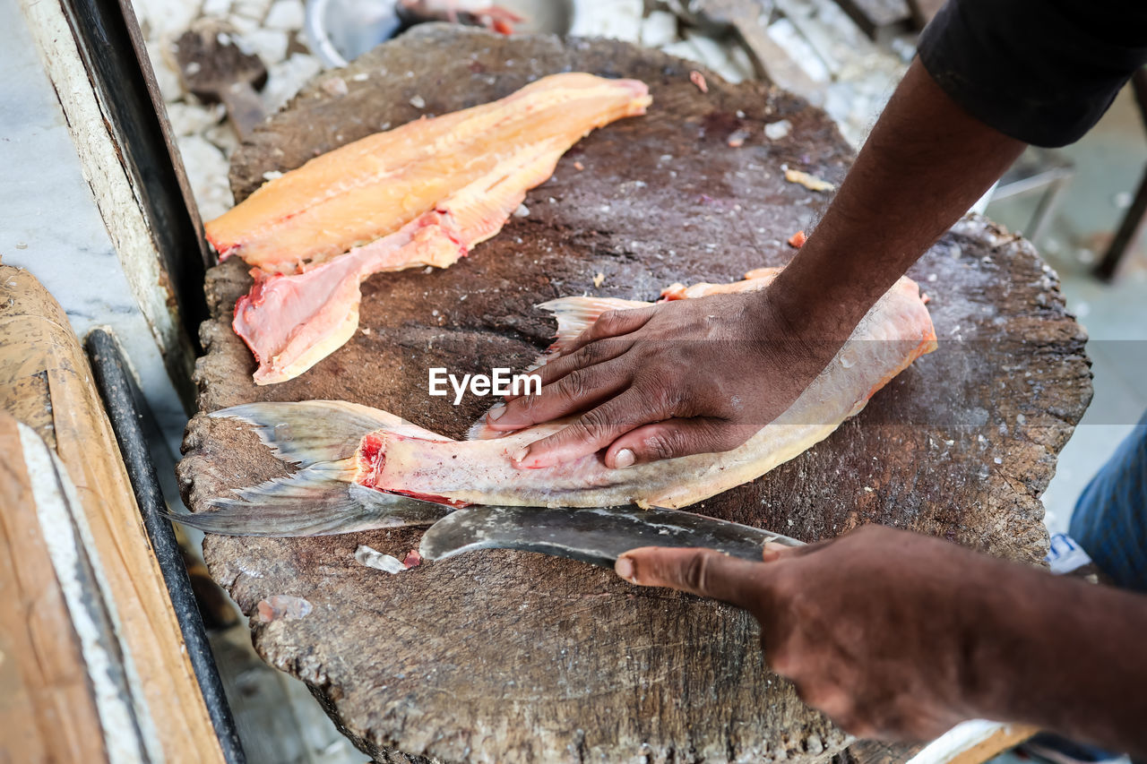 Fresh fish cutting at retail shop for sale at day from different angle