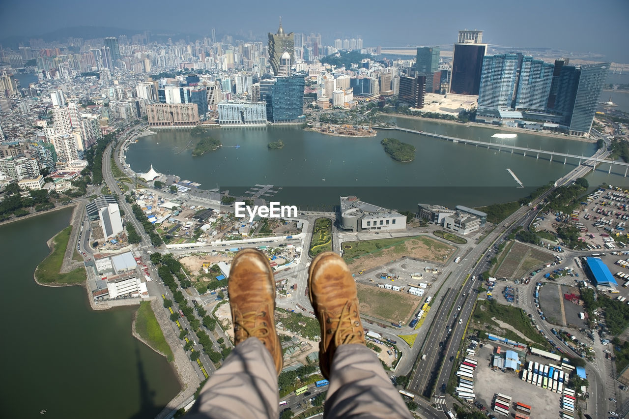Low section of man against cityscape