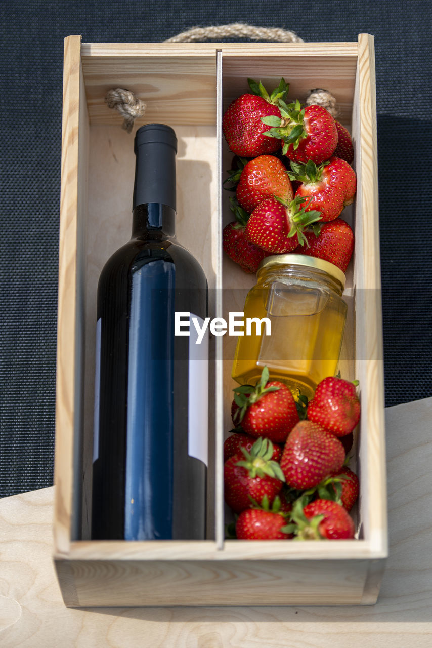 food and drink, container, strawberry, food, berry, healthy eating, fruit, freshness, wellbeing, bottle, red, studio shot, indoors, box, household equipment, no people, produce, wood, drink, refreshment, still life, open, glass