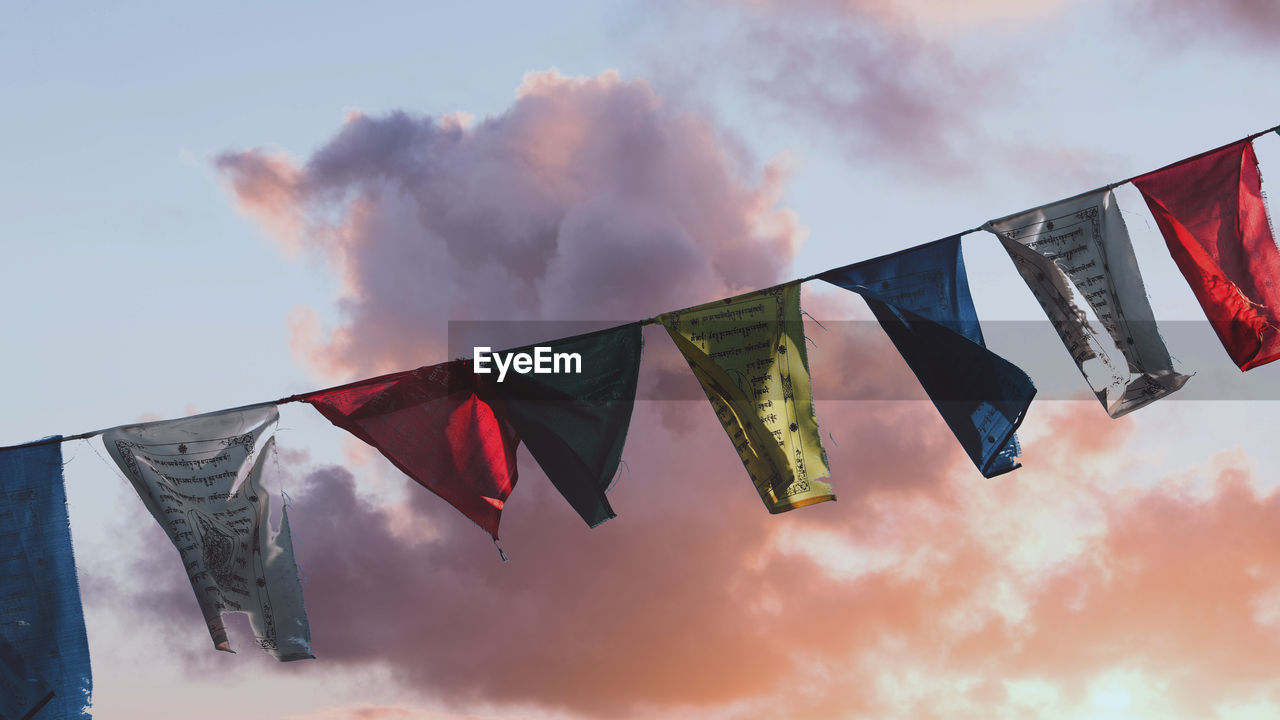 LOW ANGLE VIEW OF FLAGS AGAINST SKY