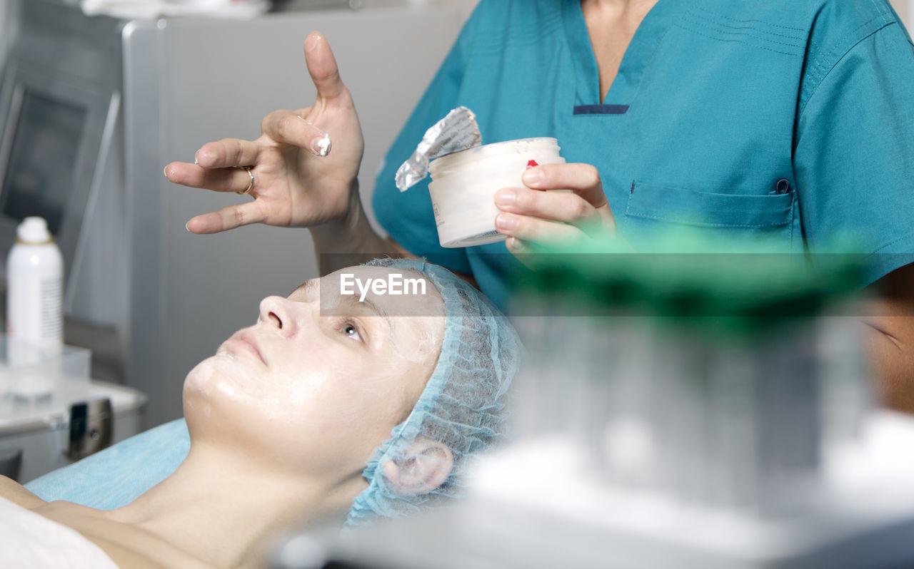 Close-up of woman getting beauty treatment from doctor