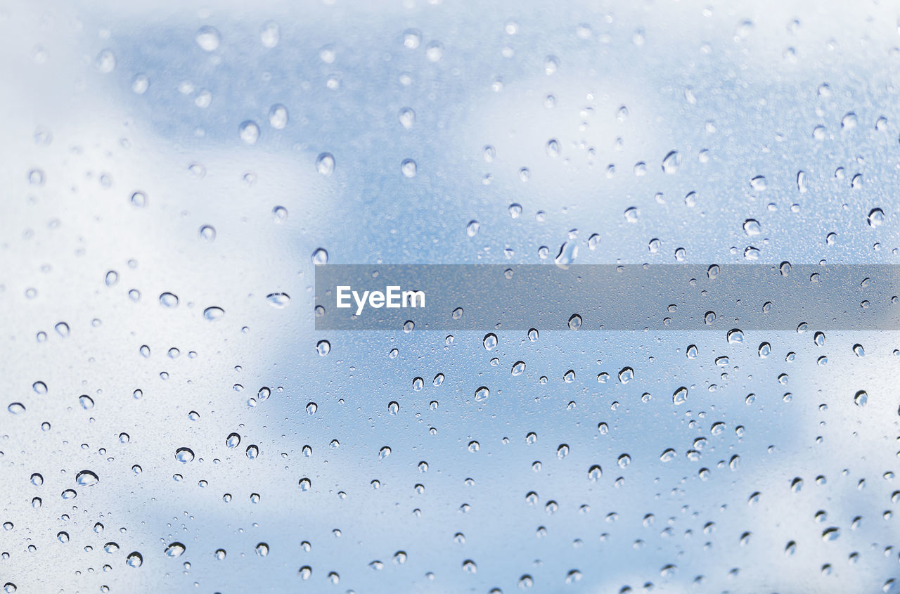 FULL FRAME SHOT OF WATER DROPS ON GLASS WINDOW