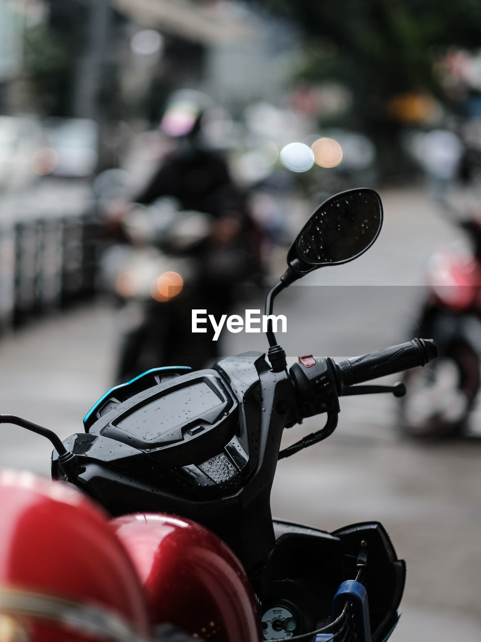 Close-up of a motorcycle with safety helmets parked on the street