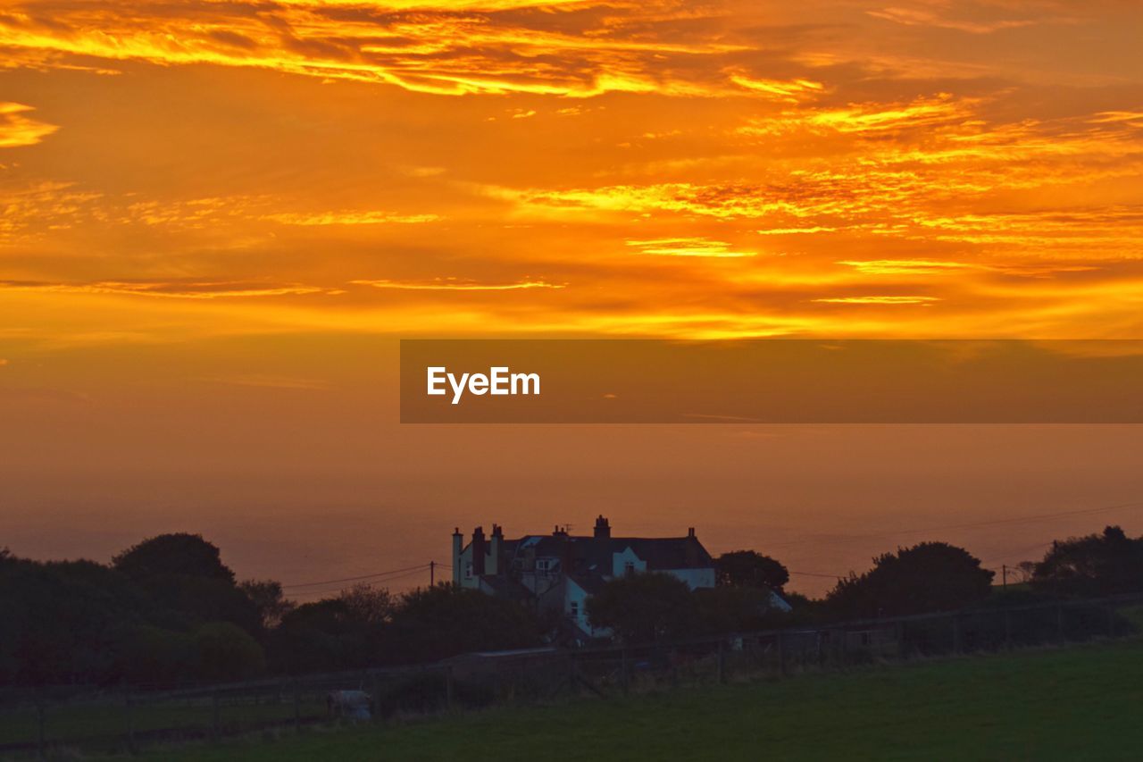 SCENIC VIEW OF FIELD AT SUNSET