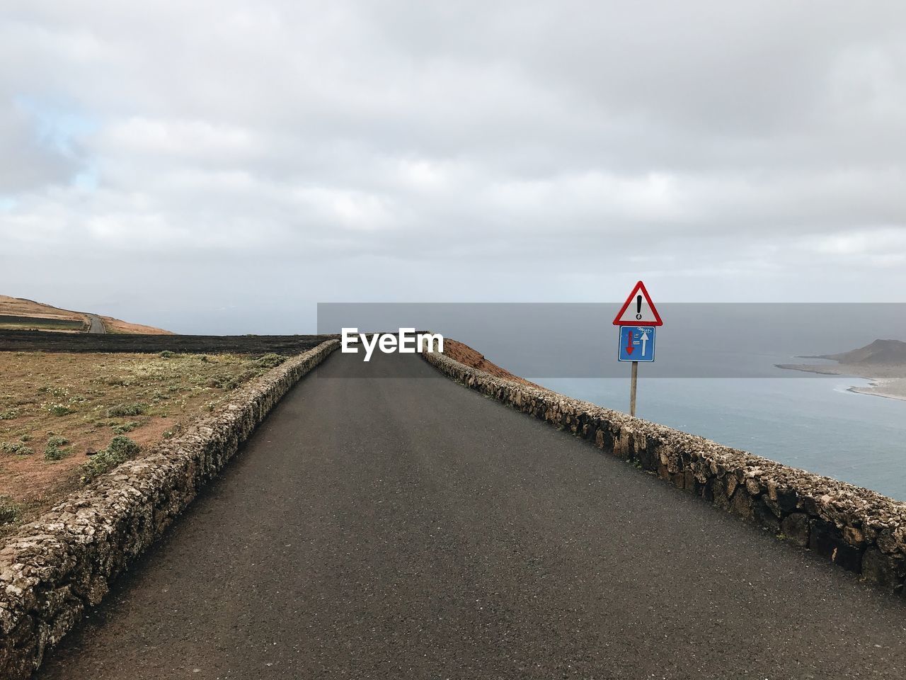 ROAD SIGN AGAINST SKY DURING SUNRISE