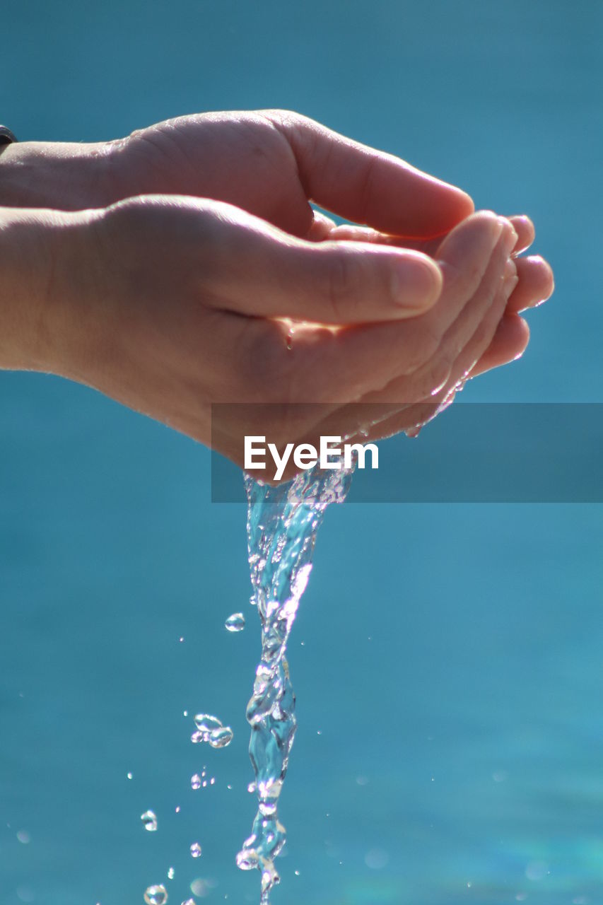 Close-up of human hands holding water