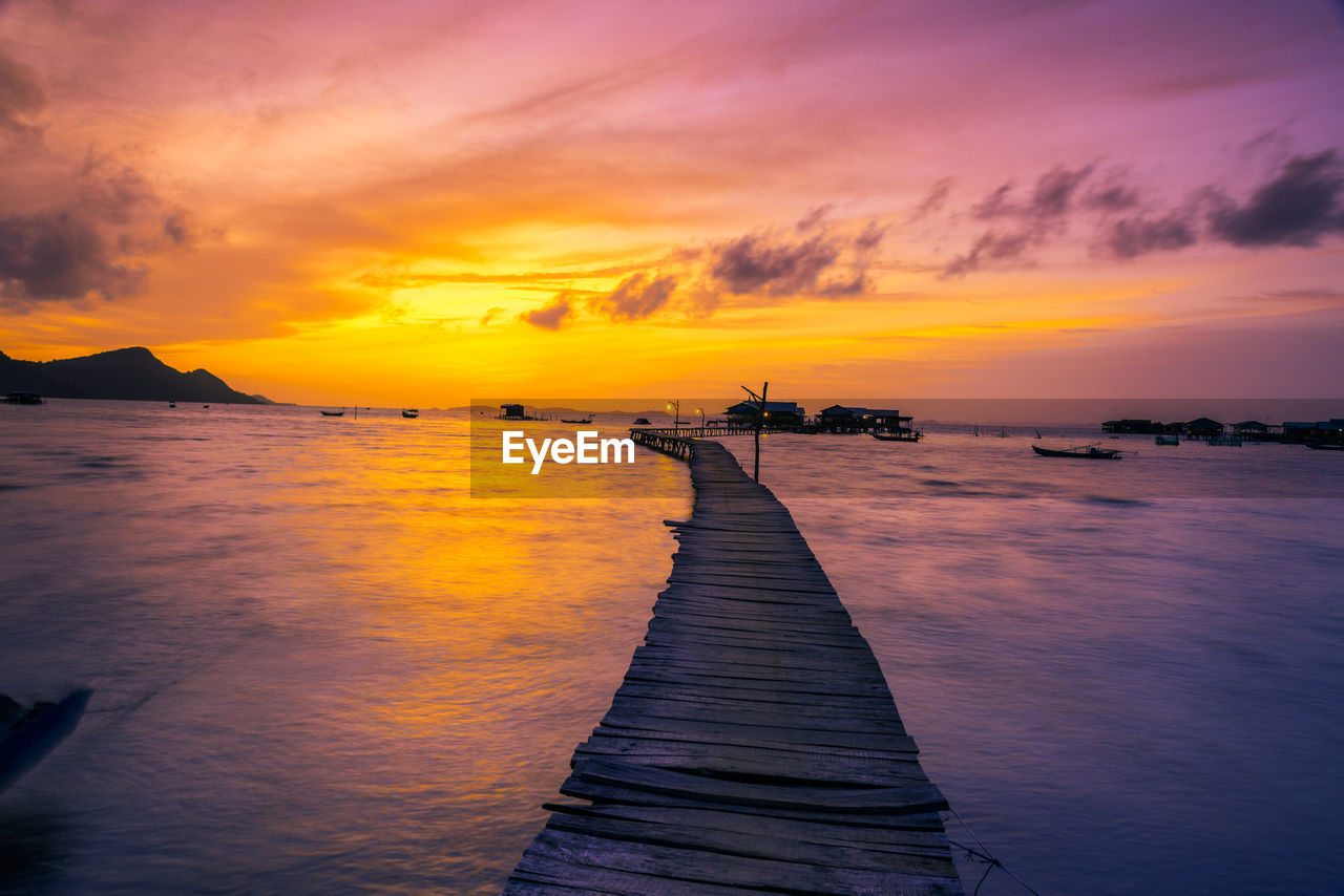 Scenic view of sea against orange sky