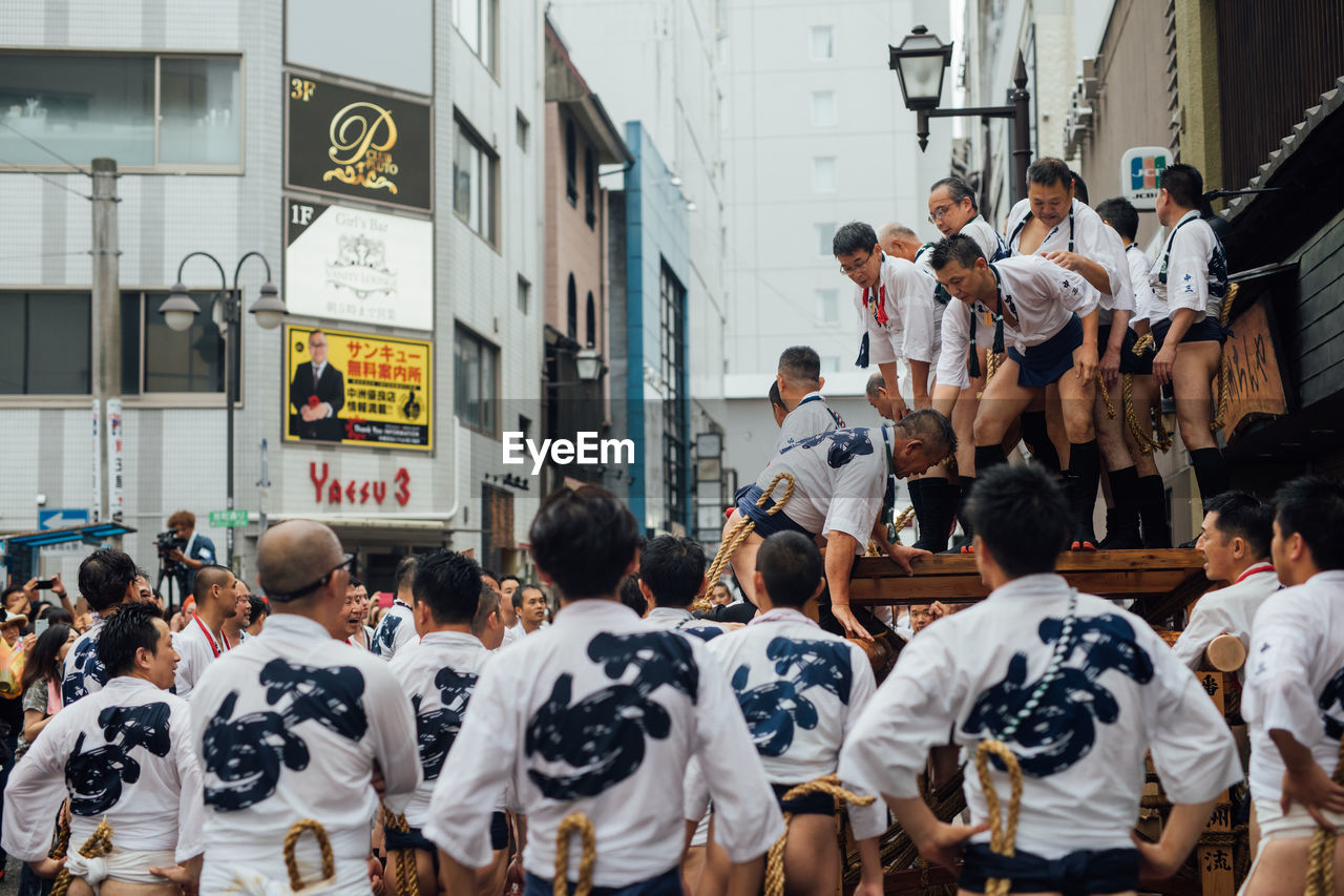 GROUP OF PEOPLE WALKING IN CITY