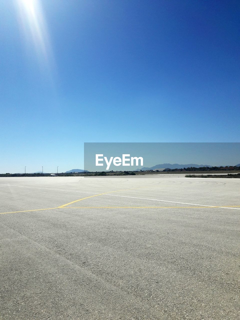 VIEW OF AIRPORT RUNWAY AGAINST CLEAR SKY