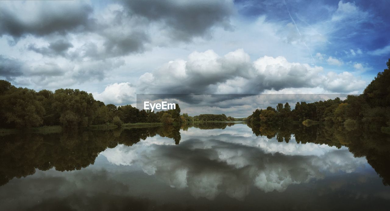 Panoramic view of lake and trees against sky