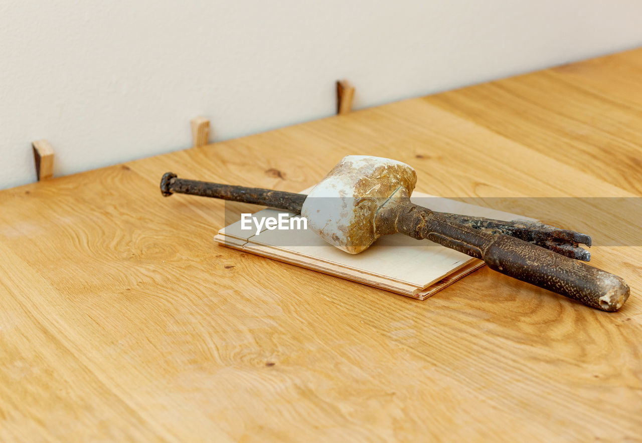 close-up of hammer on wooden table