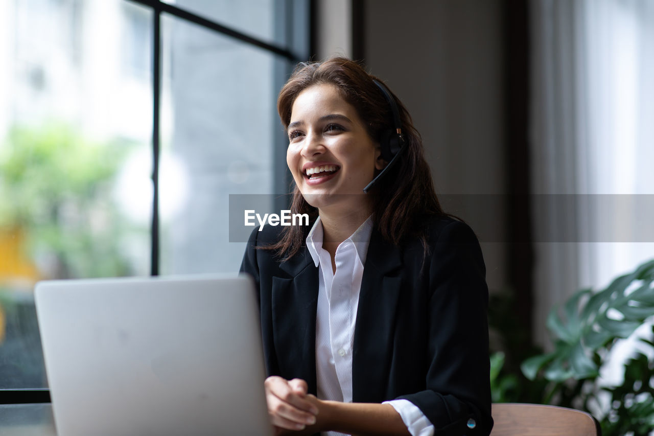 Portrait of a smiling young woman working at office