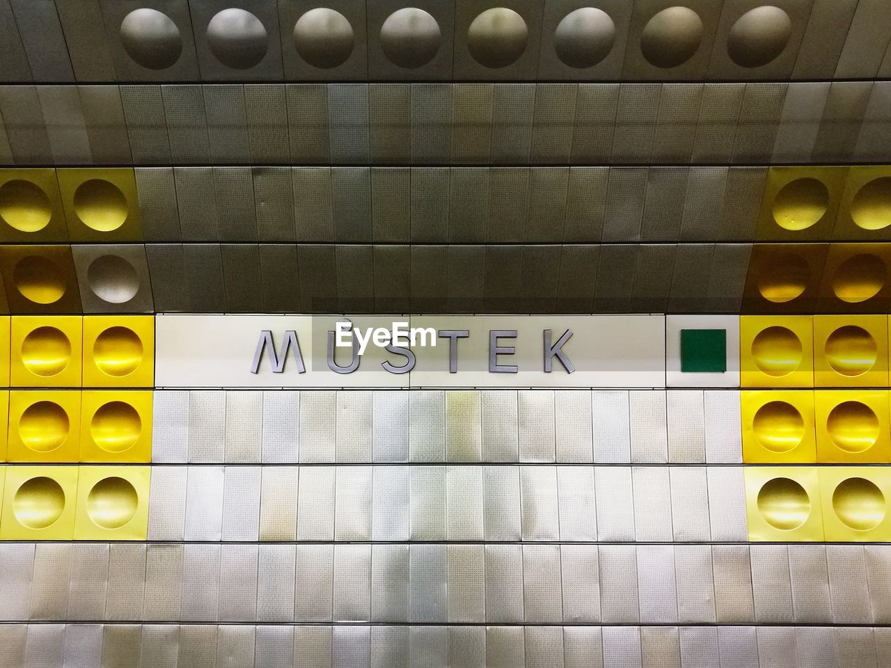 HIGH ANGLE VIEW OF ILLUMINATED TEXT ON SUBWAY STATION