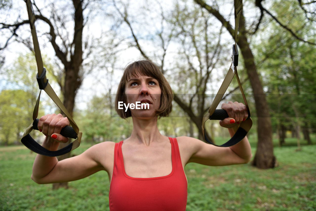 Mid adult woman exercising at public park