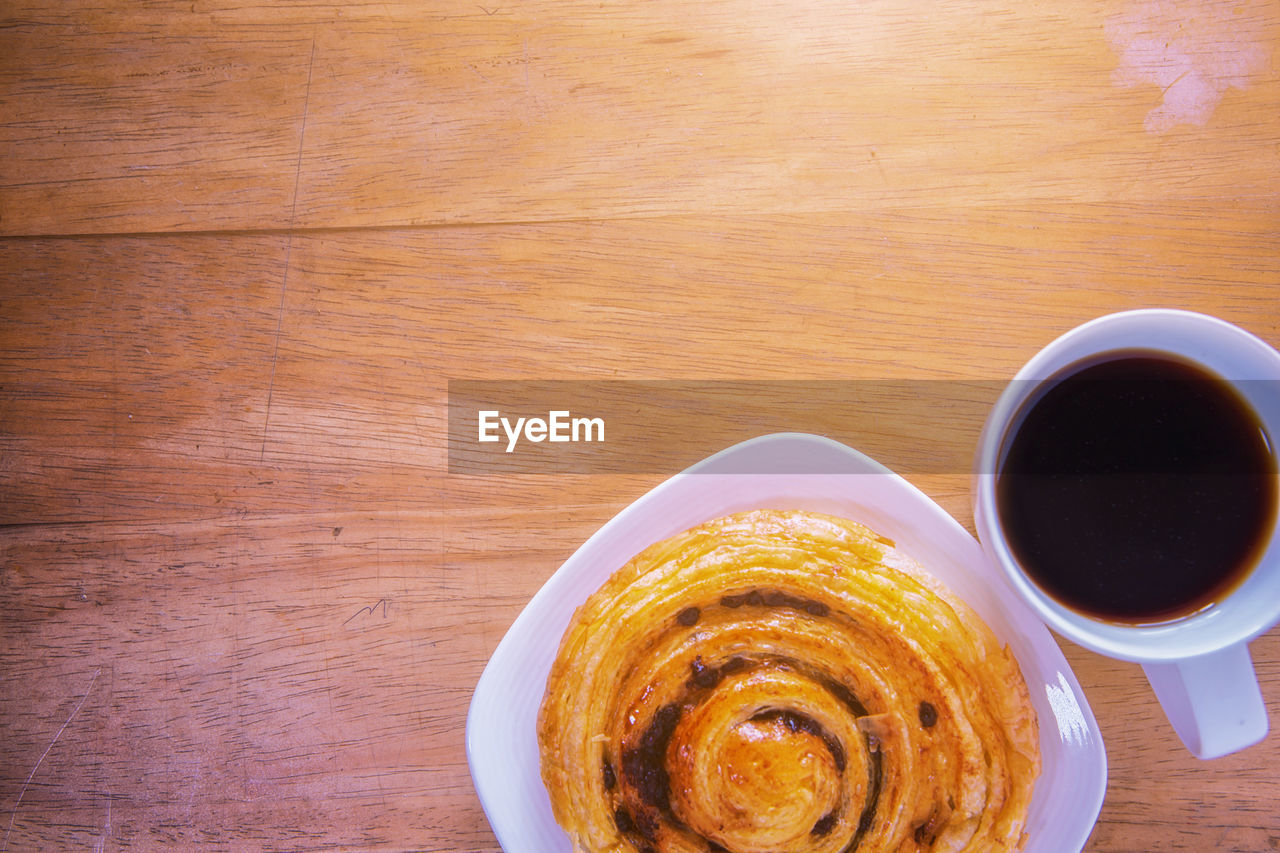 Directly above shot of sweet food with coffee on table