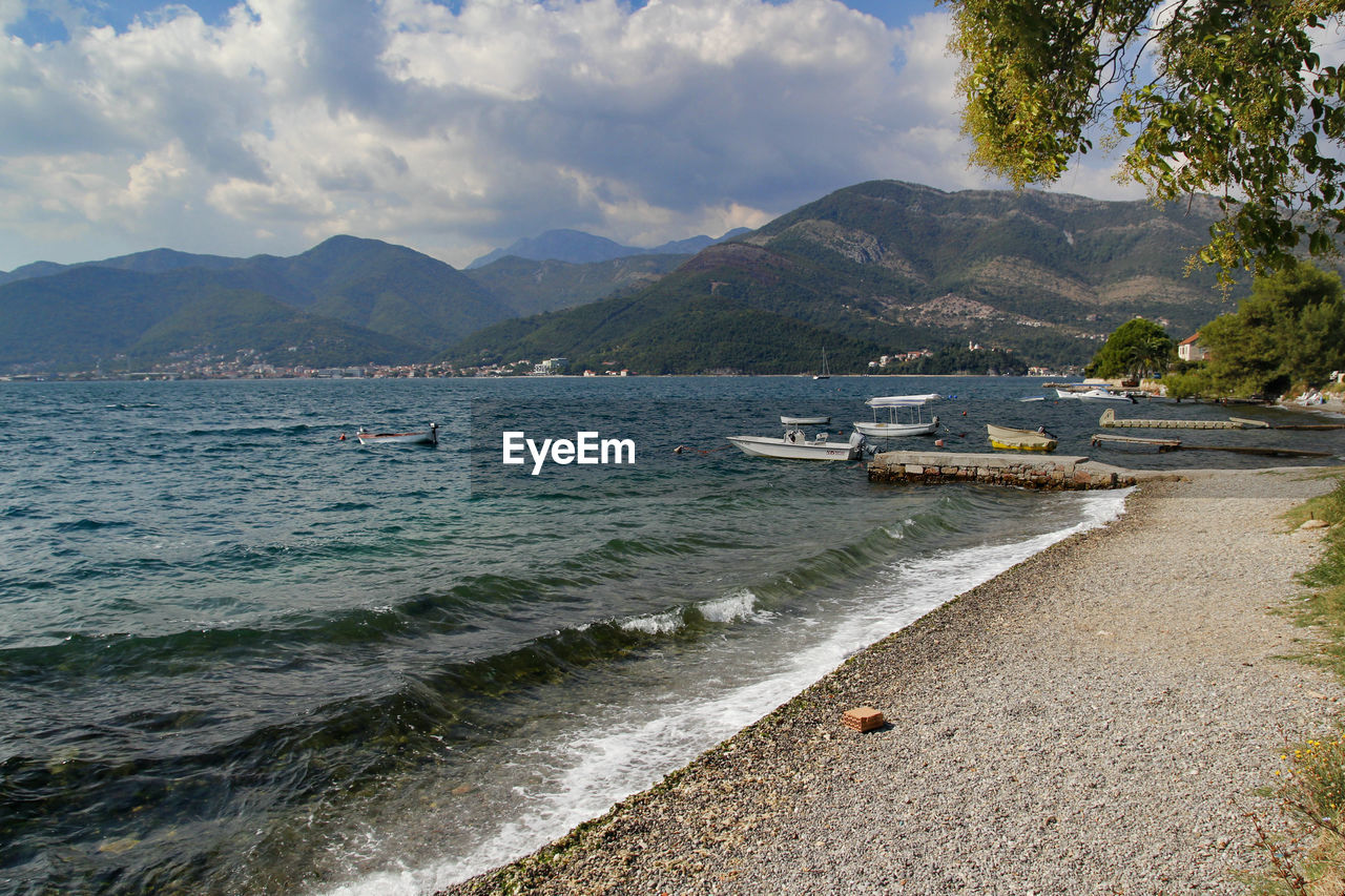 Scenic view of sea and mountains against sky