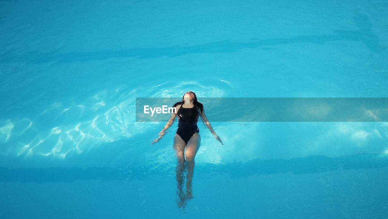 High angle view of woman swimming in pool