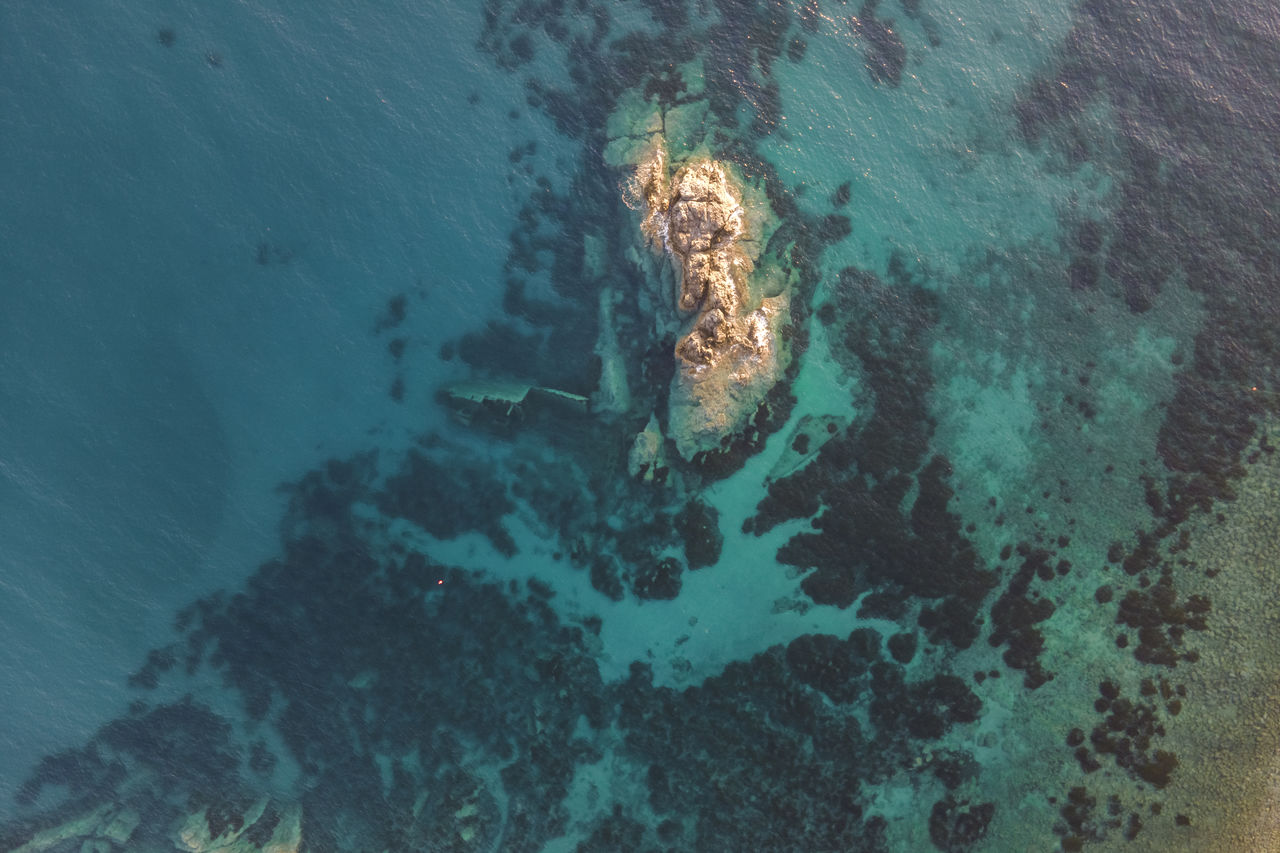 high angle view of rock formations in sea