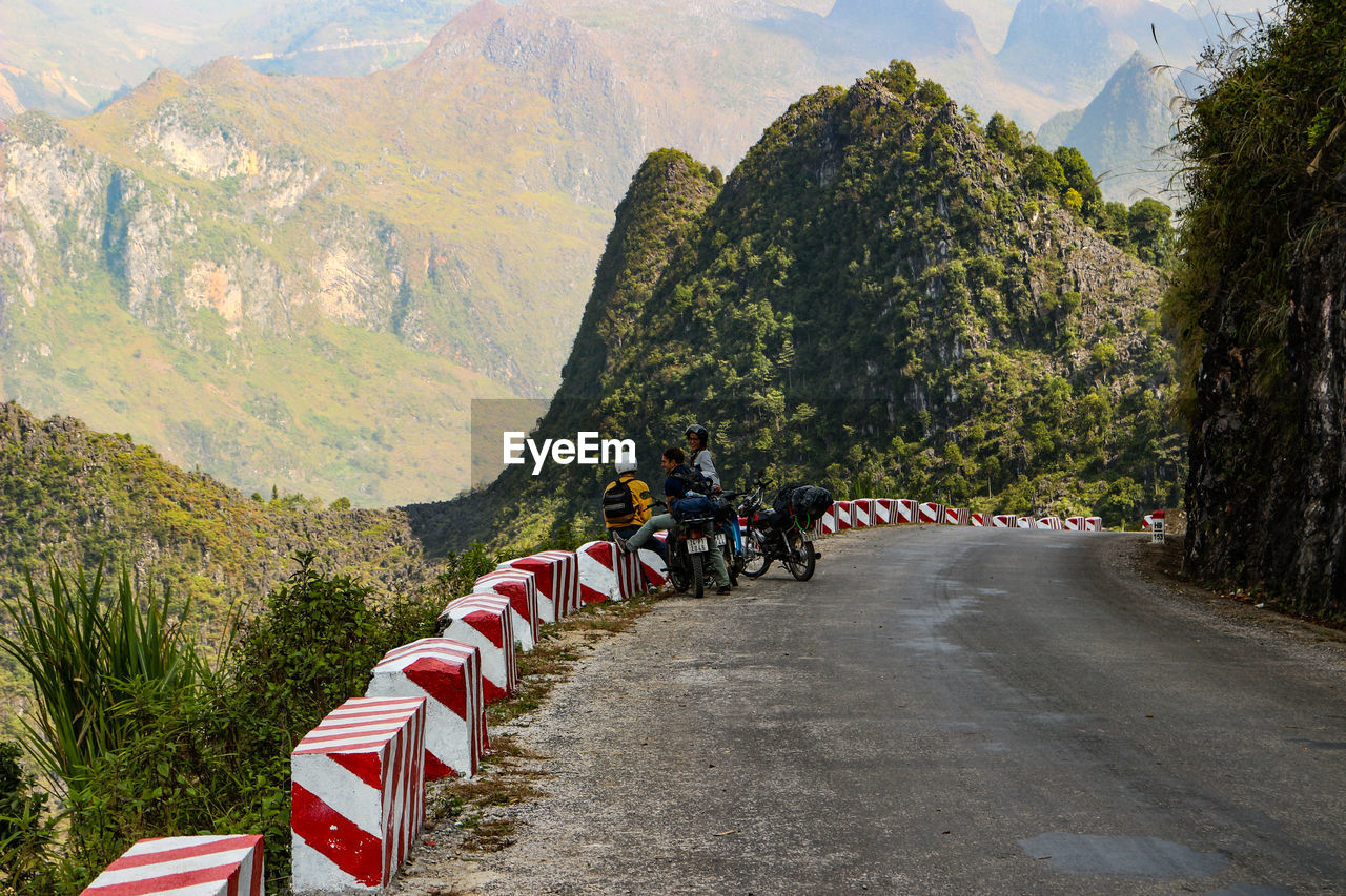 GROUP OF PEOPLE RIDING BICYCLE ON ROAD