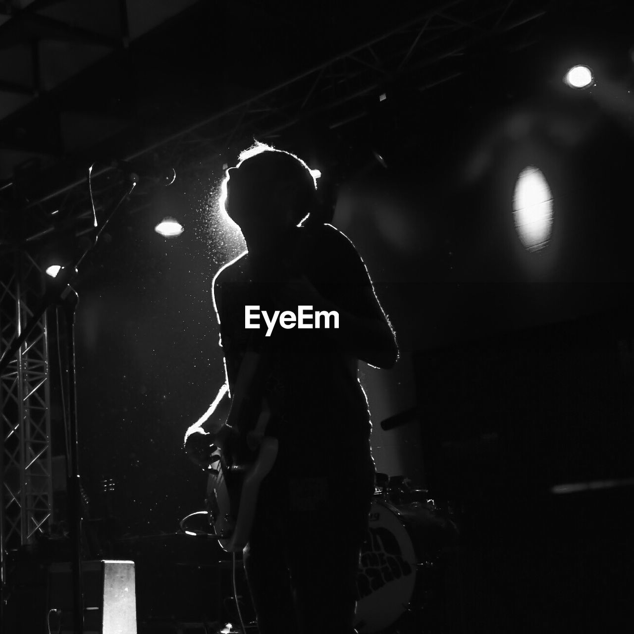 Low angle view of silhouette man playing guitar during concert