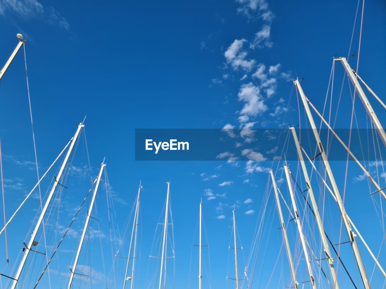 LOW ANGLE VIEW OF SAILBOAT IN BLUE SKY