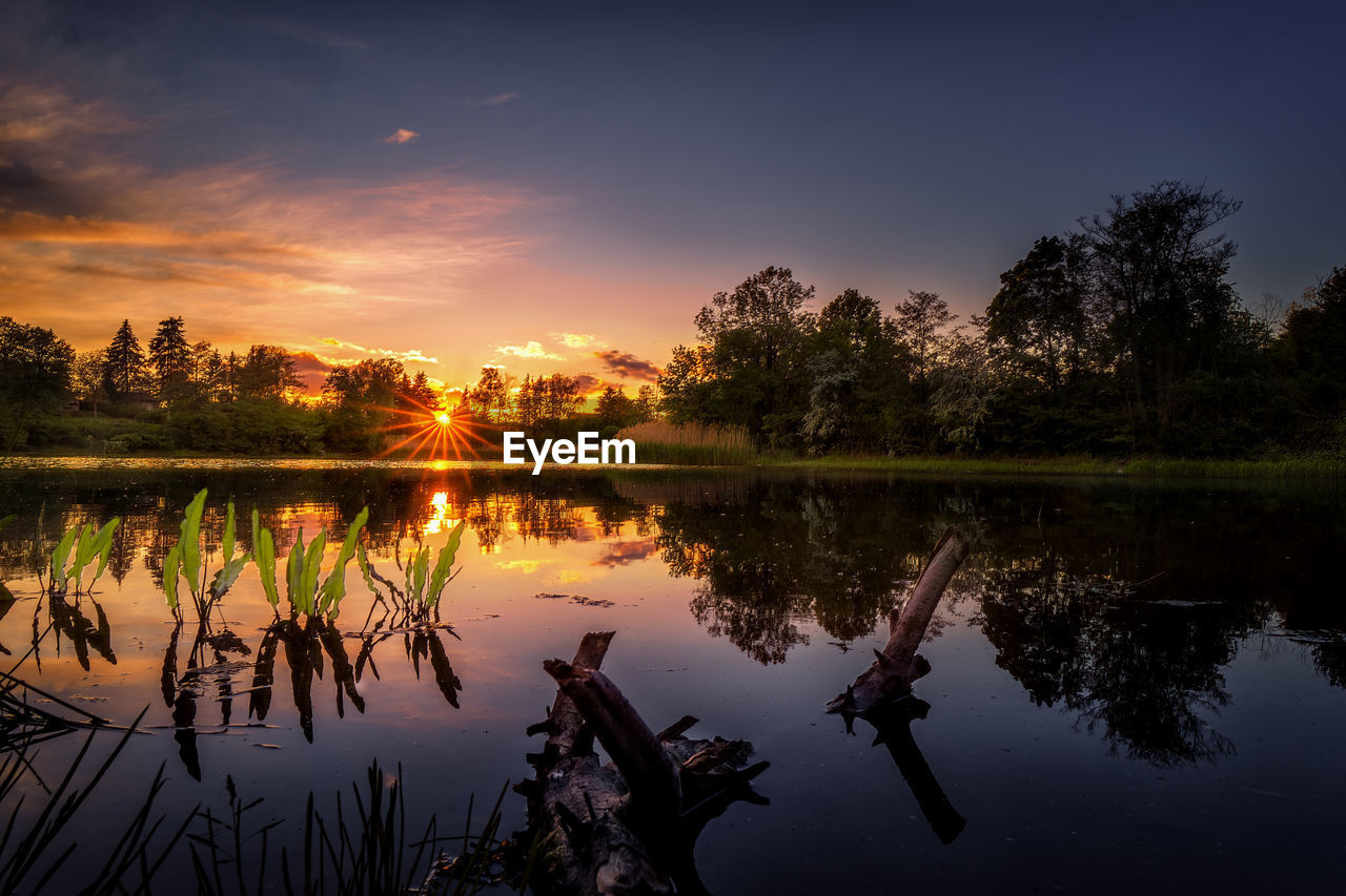 Scenic view of lake against sky during sunset