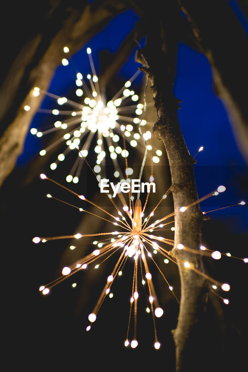 LOW ANGLE VIEW OF FIREWORKS DISPLAY AT NIGHT