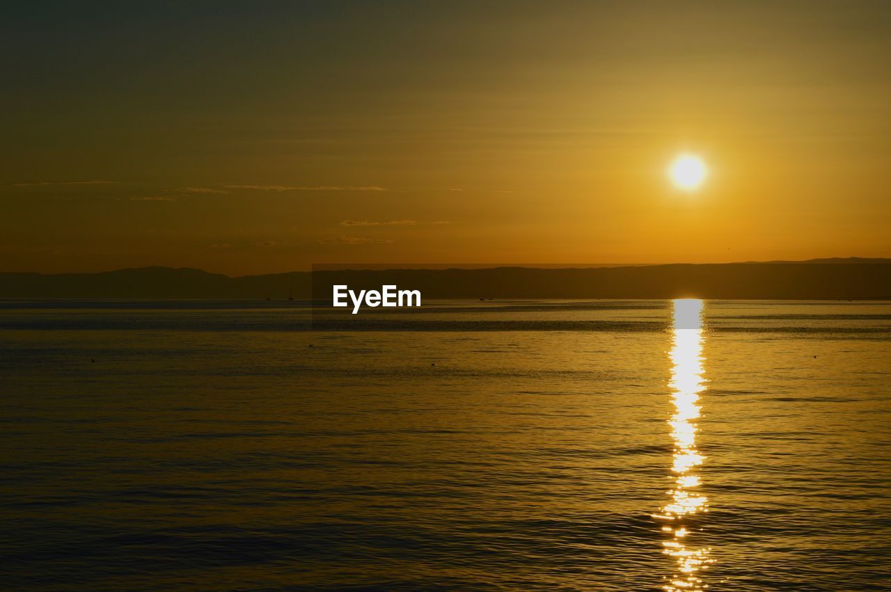 SCENIC VIEW OF SEA AND YELLOW SKY DURING SUNSET