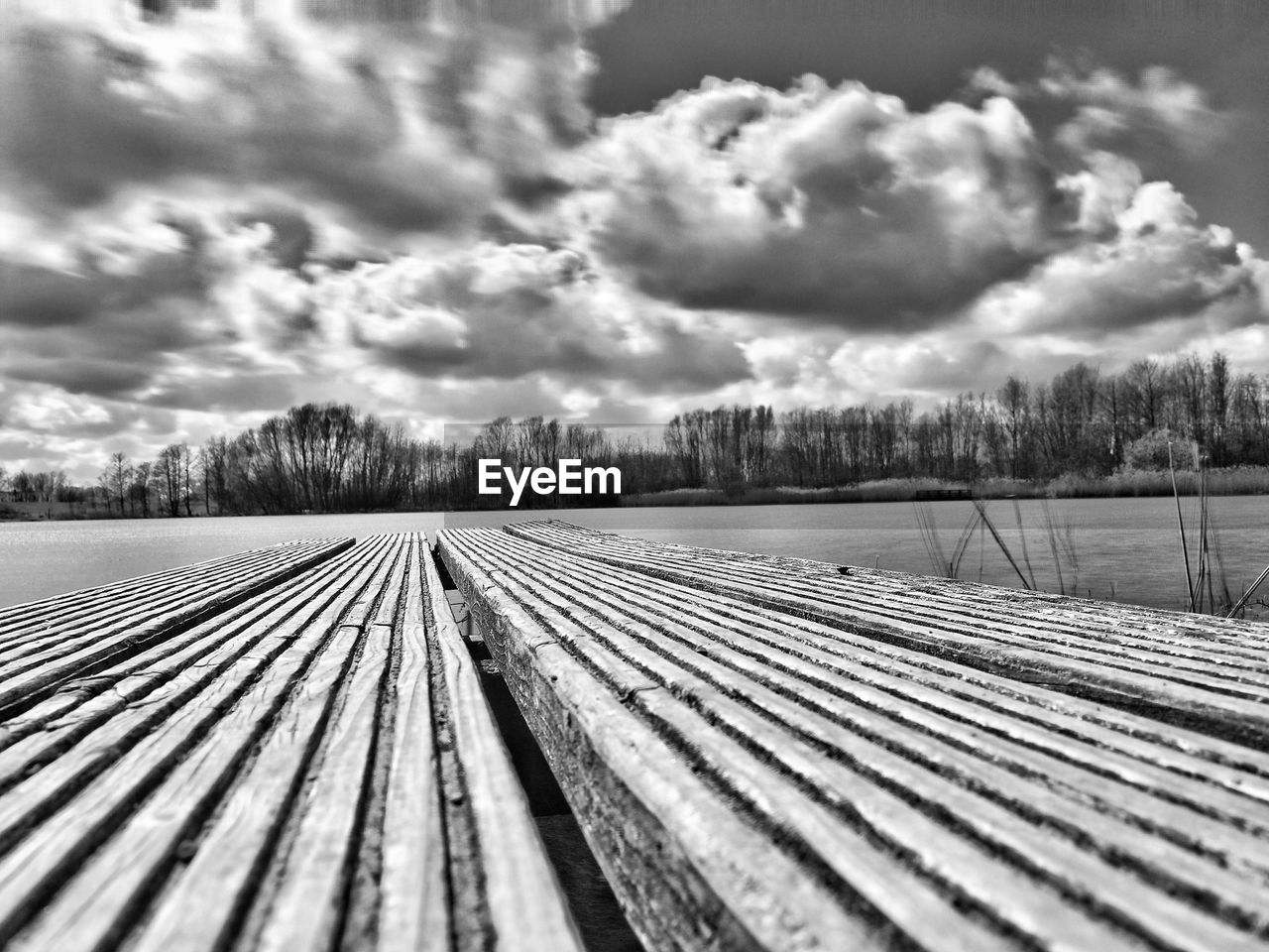 Wooden boardwalk overlooking calm lake