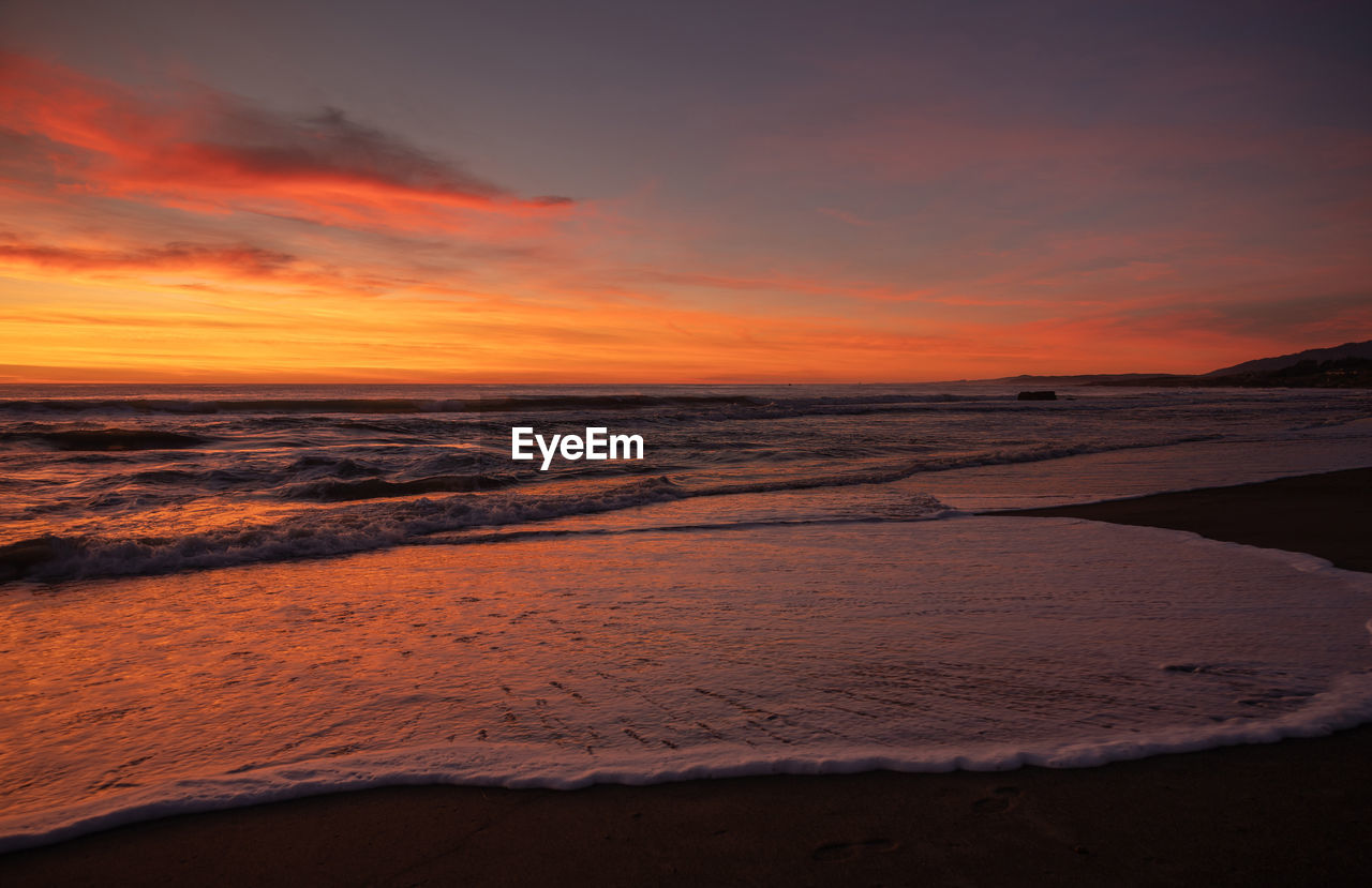 scenic view of beach during sunset