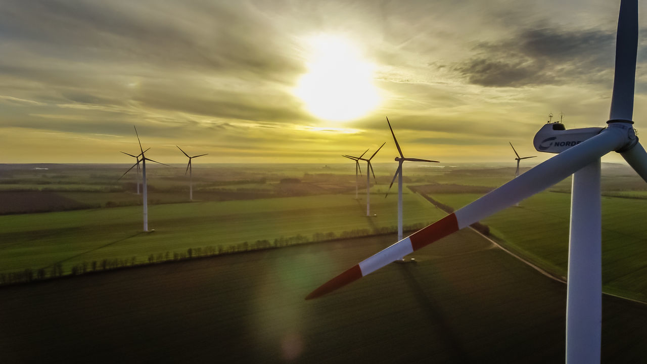 CLOSE-UP OF WIND TURBINES AGAINST SKY