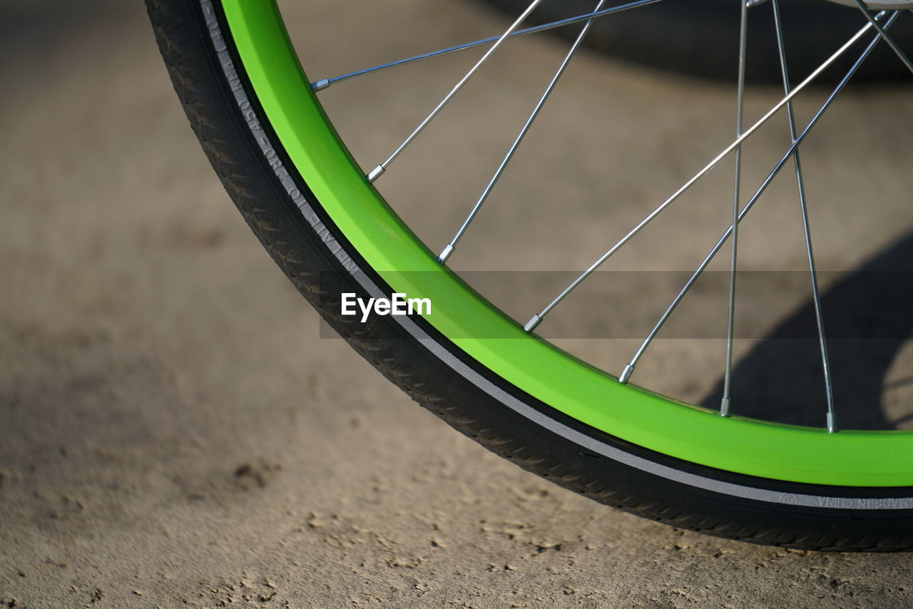 CLOSE-UP OF BICYCLE TIRE ON CAR